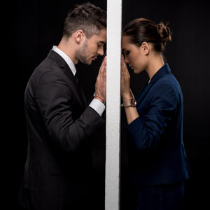 A couple gazing at each other through a doorway in Maryland Divorce Cases - Greenberg Legal Group LLC